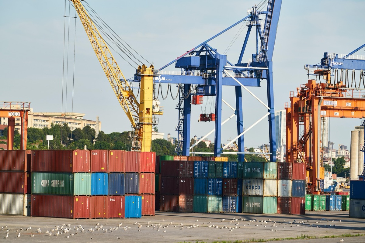 Indonesian coal export terminal with cargo trucks and workers
